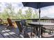 Outdoor deck showcasing a dining set with seating for six and natural surroundings at 20600 Rangeview Dr, Morrison, CO 80465