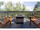 Outdoor deck featuring a modern fire pit, wooden furniture and scenic mountain views at 20600 Rangeview Dr, Morrison, CO 80465