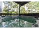 Outdoor deck featuring a relaxing hot tub with views of the surrounding trees at 20600 Rangeview Dr, Morrison, CO 80465