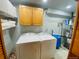 Functional laundry room equipped with washer, dryer, and storage cabinets for added convenience at 20600 Rangeview Dr, Morrison, CO 80465