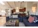 Open-concept living area with modern sofas and a stylish kitchen at 20600 Rangeview Dr, Morrison, CO 80465