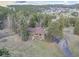 Aerial view of home featuring mature trees and a paved driveway at 8473 Gray Fox Dr, Evergreen, CO 80439