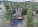 Aerial view of home featuring mature trees and a long driveway at 8473 Gray Fox Dr, Evergreen, CO 80439