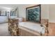 Jetted tub in bathroom with stone wall and a view out of the window and natural light at 8473 Gray Fox Dr, Evergreen, CO 80439