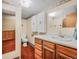 Well-lit bathroom featuring vanity storage, mirror, and toilet at 8473 Gray Fox Dr, Evergreen, CO 80439
