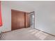 Neutral bedroom with closet and door offering a view into the next room with natural light at 8473 Gray Fox Dr, Evergreen, CO 80439