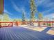 Inviting deck area perfect for outdoor dining and relaxation with scenic views of trees and blue sky at 8473 Gray Fox Dr, Evergreen, CO 80439