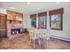 Cozy dining area features a brick fireplace, large windows, and plenty of natural light at 8473 Gray Fox Dr, Evergreen, CO 80439