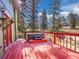 Back deck featuring a hot tub with scenic views and outdoor space at 8473 Gray Fox Dr, Evergreen, CO 80439