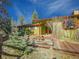 Charming home featuring a wooden path leading up to the entrance, surrounded by lush greenery and trees at 8473 Gray Fox Dr, Evergreen, CO 80439