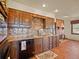 Traditional kitchen features custom wood cabinets, granite countertops, and brick fireplace at 8473 Gray Fox Dr, Evergreen, CO 80439