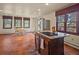 Bright open kitchen boasts an island with cooktop, stainless appliances, and eating space at 8473 Gray Fox Dr, Evergreen, CO 80439