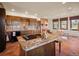 Eat-in kitchen view with island, breakfast nook, brick fireplace, and stainless appliances at 8473 Gray Fox Dr, Evergreen, CO 80439