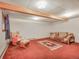 Unfinished basement featuring a rocking chair, sofa, and rug on the carpet at 8473 Gray Fox Dr, Evergreen, CO 80439
