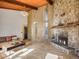 Spacious living room with stone fireplace, hardwood floors, wooden accent wall, and cozy seating area at 8473 Gray Fox Dr, Evergreen, CO 80439