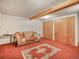 Unfinished basement space with sofa and ample storage featuring two closets at 8473 Gray Fox Dr, Evergreen, CO 80439