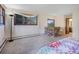 Primary bedroom with large windows and stone wall above an jetted tub and carpet flooring at 8473 Gray Fox Dr, Evergreen, CO 80439