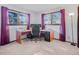 Office space with corner desk setup, ample natural light from the windows, and carpet at 8473 Gray Fox Dr, Evergreen, CO 80439
