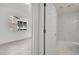 Bathroom view into bedroom space featuring marble tiled shower and light colored hardwood floors at 18761 E Water Dr # F, Aurora, CO 80013