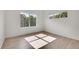 Bright bedroom featuring hardwood floors, a large window, and neutral walls at 18761 E Water Dr # F, Aurora, CO 80013