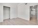 Bright bedroom featuring a closet, hardwood floors, and a doorway to another room at 18761 E Water Dr # F, Aurora, CO 80013