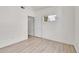 Neutral bedroom featuring hardwood floors, a window, and a doorway at 18761 E Water Dr # F, Aurora, CO 80013