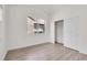 Light and airy bedroom featuring hardwood floors, window, and a closet at 18761 E Water Dr # F, Aurora, CO 80013