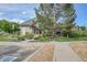 Exterior view of clubhouse with accessible entrance, landscaped grounds, and designated parking at 18761 E Water Dr # F, Aurora, CO 80013