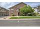 Exterior view of the townhome featuring a stone facade, landscaping, and an entry stairway at 18761 E Water Dr # F, Aurora, CO 80013