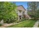 Charming townhome featuring a stone facade, private entrances, and lush green landscaping at 18761 E Water Dr # F, Aurora, CO 80013