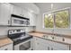 Close-up of updated kitchen appliances and fixtures under plenty of natural light at 18761 E Water Dr # F, Aurora, CO 80013