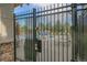 Black metal fence and coded gate for community pool with a 'Pool Closed' notice at 18761 E Water Dr # F, Aurora, CO 80013