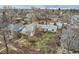 Aerial view of the home in a residential neighborhood, showcasing the yard and mature trees at 1824 S Logan St, Denver, CO 80210