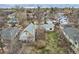 Aerial view of the home in a residential neighborhood, showcasing the yard and mature trees at 1824 S Logan St, Denver, CO 80210