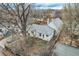 An aerial view of the property showing the house's roof, yard, and surrounding neighborhood at 1824 S Logan St, Denver, CO 80210