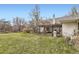 The home's backyard is a grass-covered expanse featuring a covered patio area and grill at 1824 S Logan St, Denver, CO 80210