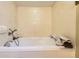 Bright bathroom with a luxurious soaking tub and marble-like tile surround at 1824 S Logan St, Denver, CO 80210