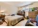 Bedroom featuring an air conditioning unit, ample storage and a cozy bed at 1824 S Logan St, Denver, CO 80210