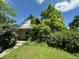 Home partially obscured by lush greenery with a peaked roof and a visible house number at 1824 S Logan St, Denver, CO 80210