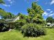 Charming home exterior with a verdant front yard beneath a clear blue sky at 1824 S Logan St, Denver, CO 80210