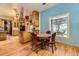 Charming eat-in kitchen with wood cabinets, plants hanging, and a bright, airy window at 1824 S Logan St, Denver, CO 80210