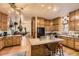 Open kitchen with oak cabinets, central island, and eat-in breakfast nook adjacent to living room at 1824 S Logan St, Denver, CO 80210