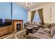Cozy living room with a fireplace, hardwood floors, and comfortable seating at 1824 S Logan St, Denver, CO 80210