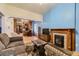 Inviting living room with a cozy fireplace and an open layout to the kitchen area at 1824 S Logan St, Denver, CO 80210