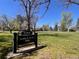James H. Platt Park sign with lush green lawns and mature trees under a clear blue sky on a sunny day at 1824 S Logan St, Denver, CO 80210