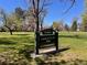 James H. Platt Park sign surrounded by lush green lawns and mature trees under a clear blue sky at 1824 S Logan St, Denver, CO 80210
