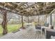 Covered patio with rustic wood beams and a seating area for outdoor entertaining at 1824 S Logan St, Denver, CO 80210