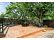 Expansive backyard with a stone patio, outdoor dining area, mature trees, and well-manicured garden at 4968 Alcott St, Denver, CO 80221