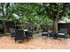 Beautiful backyard with stone patio, outdoor dining set, fire pit, and lush green landscaping at 4968 Alcott St, Denver, CO 80221