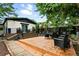 Spacious backyard with a multi-level stone patio, outdoor seating, and lush green landscaping at 4968 Alcott St, Denver, CO 80221